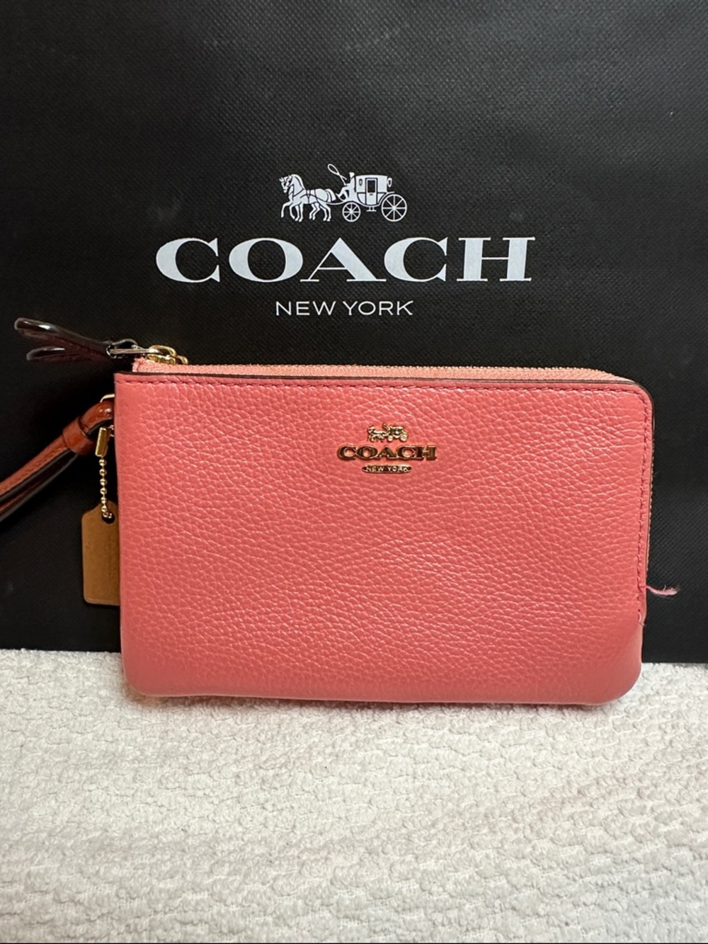 COACH Pebbled Leather Wristlet in Coral